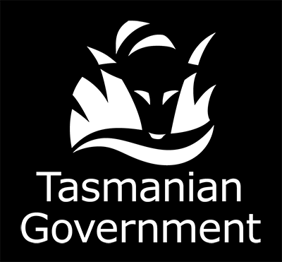Tasmanian Government logo in white on black background, consisting of a tasmanian tiger looking through grass into water with the words Tasmanian Government below.
