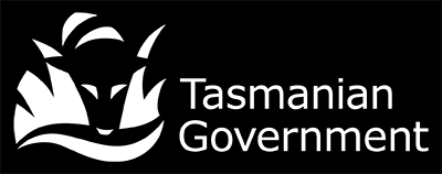 Tasmanian Government logo in white on black background, consisting of a tasmanian tiger looking through grass into water with the words Tasmanian Government to the right.